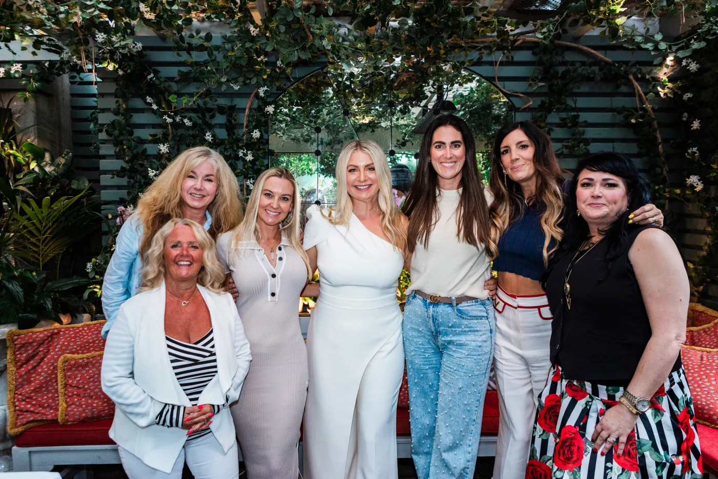 Emily Williams with guests beneath greenery at a London event